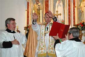 Bishop Fellay hands outstretched