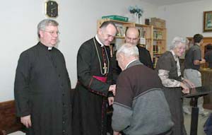 parishioner kisses bishop's ring