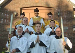 Fr. Mery with priests and servers on front steps