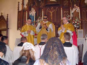 Fr. Mery prepares to give Holy Communion to the faithful