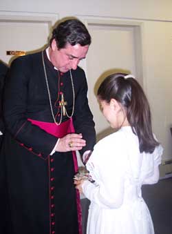 Bishop blessing religious articles