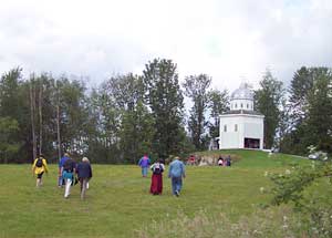 Pilgrims climb the last hill to the grotto of Our Lady of Lourdes