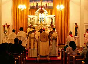 bishop and priests infront of altar