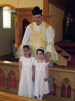 Fr. Ockerse with two of the First Communicants