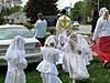 children in white process with priest