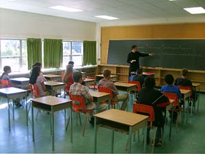 Priest teaches catechism in classroom