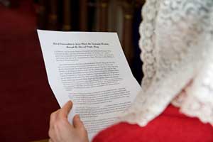 Parishioner reading consecration prayer