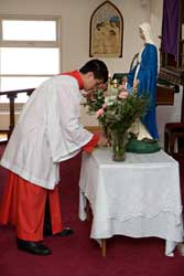 Altar boy signs his consecration at Our Lady's altar