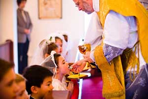 Girl receives First Holy Communion