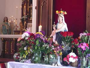 Our Lady surrounded in flowers