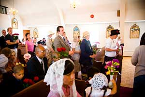 parishioners advancing with flowers