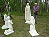 Parishioer stands next to life size statues of Fatima apparition