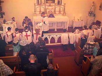 Priest at altar rail receiving Crusaders