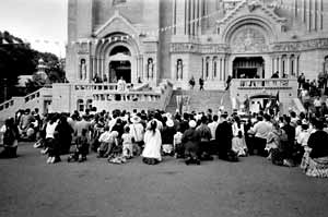 Pilgrims kneel outside of St. Anne de Beaupre