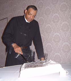 Fr. Mery cuts the cake