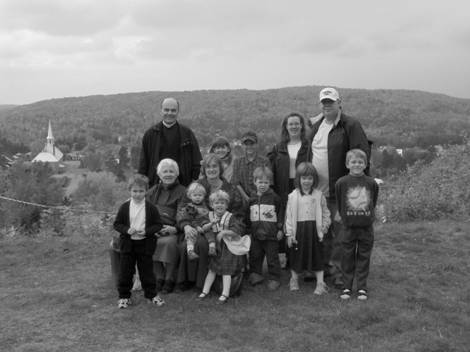 family and priest hiking