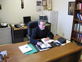 Father Scott at his desk