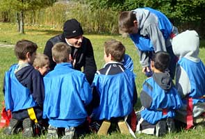 Fr May instructs boys in rugby tactics