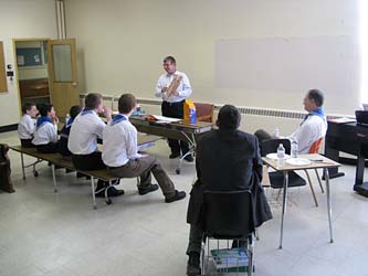 Scout leader explains bridge building to boys