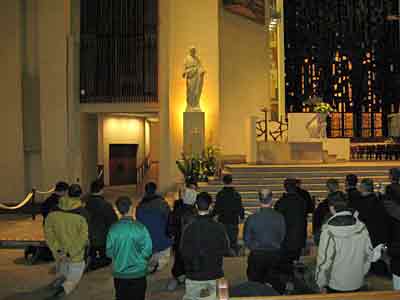 Prayers at the statue of St Joseph