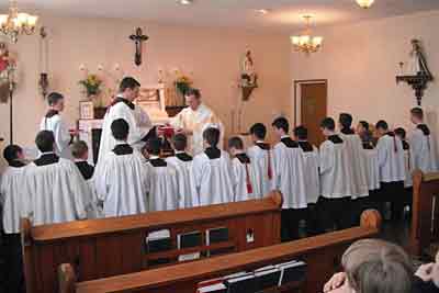 Fr Scott distributes medals and cords for the Archconfraternity of St. Stephen