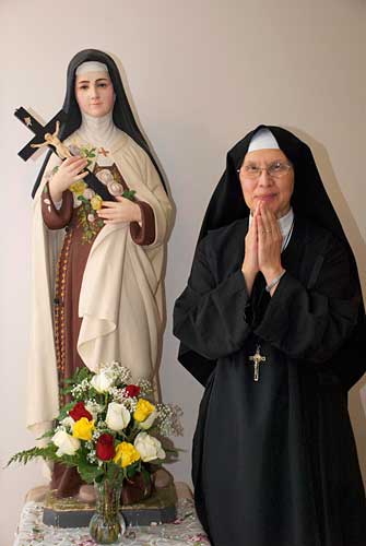 Sister with Saint Terese of the Child Jesus statue