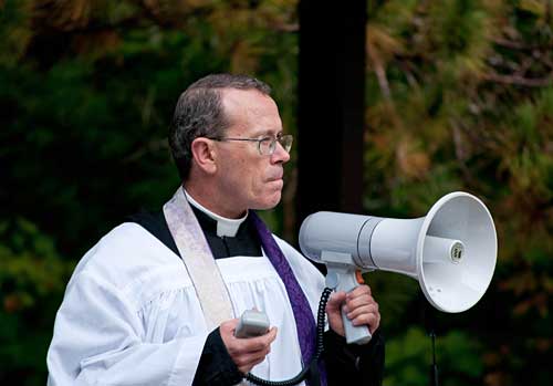 priest with megaphone