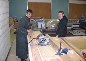 priest and student in workshop