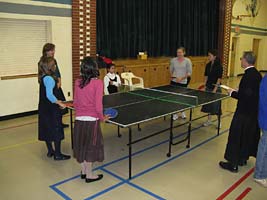 priest and girls at ping pong