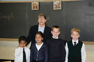 Mrs. Tonogai and her four students in their classroom.